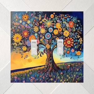 May include: A double light switch cover featuring a vibrant, colorful painting of a tree with stylized flowers in shades of yellow, orange, red, and blue against a sunset sky. The artwork includes intricate patterns and two white toggle switches.