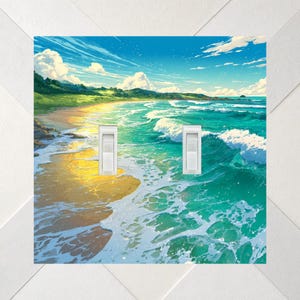 May include: A double light switch wall plate featuring a vibrant coastal landscape illustration. The design depicts a sunny beach with golden sand, turquoise ocean waves crashing against the shore, green hills, and a bright blue sky with clouds.