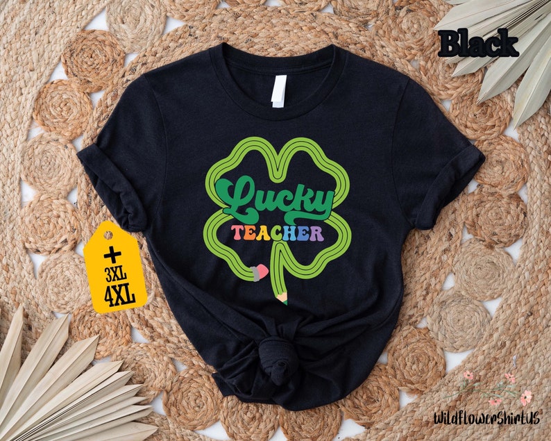 a black t - shirt with a shamrock saying lucky teacher