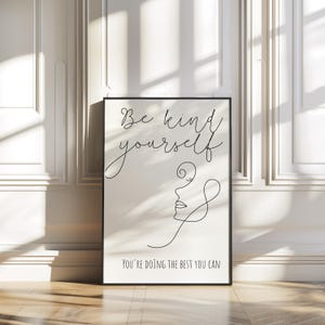 May include: Black and white printable wall art with a line drawing of a face and the text "Be kind to yourself. You're doing the best you can."