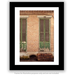 a picture of a brick building with green shutters