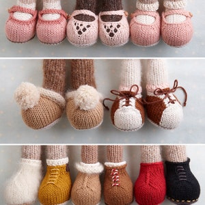 May include: A set of 10 knitted doll shoes in various styles and colours, including pink ballet slippers, brown and white sneakers, and brown, yellow, red and black boots.