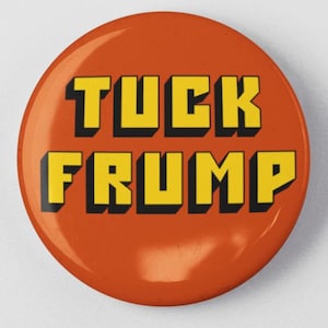May include: Orange button with the text "TUCK FRUMP" in yellow block letters.