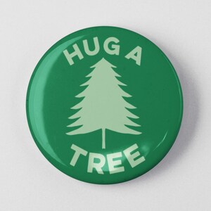 May include: Green button with the text "Hug a Tree" in white letters and a green silhouette of a pine tree.