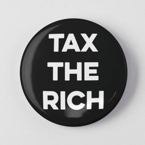 May include: A black button with white text that reads "TAX THE RICH".