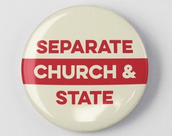 May include: A white button with a red stripe and the text "SEPARATE CHURCH & STATE" in red.