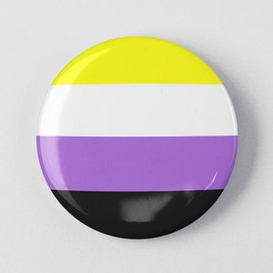 May include: A round button with the colors of the non-binary pride flag. The button is yellow, white, purple, and black.