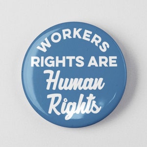 May include: A blue button with white text that reads "Workers Rights Are Human Rights".