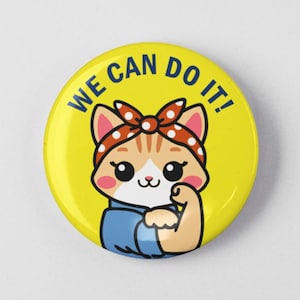 May include: A yellow button with a cartoon cat wearing a red and white bandana. The cat is flexing its bicep and the button says "We Can Do It!"