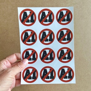 May include: A white sticker sheet featuring twelve circular stickers arranged in a four-by-three grid. Each sticker displays a bold black text reading AI with a thick red circle and a diagonal slash line crossing through the letters.