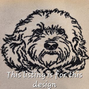 May include: A black and white knitted design of a dog's face. The dog has a fluffy, curly coat and a sweet expression. The design is on a cream-colored background. "This listing is for this design" is written below the image.