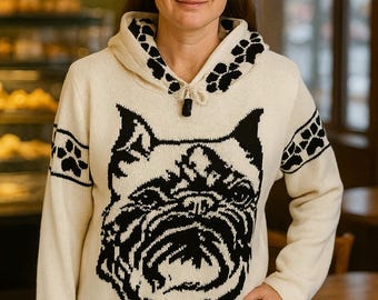 May include: Cream-colored hooded sweater featuring a large black bulldog face design on the front. The hood and sleeves have black paw print accents. The sweater has a drawstring closure at the neckline.