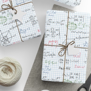May include: Three white gift boxes wrapped in white paper with a grid pattern and covered in handwritten mathematical equations and formulas. The boxes are tied with twine and have white gift tags attached.