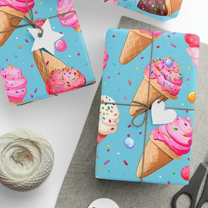 May include: Blue wrapping paper with a repeating pattern of ice cream cones with sprinkles and colorful candies. The paper is tied with twine and a white star-shaped tag.