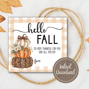 May include: A square tag with a fall theme, featuring a stack of pumpkins with a bow and floral accents. The tag reads "hello FALL" and "So very thankful for you and all you do!" with "Instant Download" text.