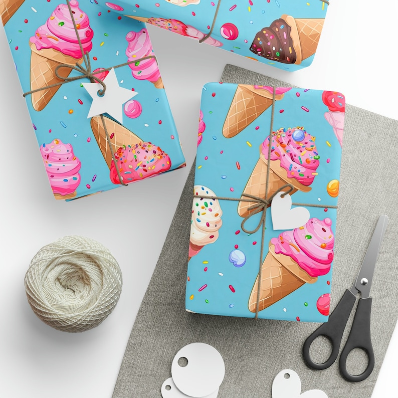 May include: Blue wrapping paper with a repeating pattern of ice cream cones with sprinkles and colorful candies. The paper is tied with twine and a white star-shaped tag.