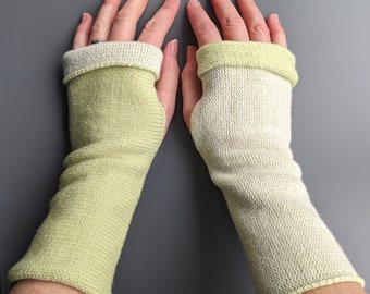 Knitted lambswool reversible wrist warmers in pastel green and ecru