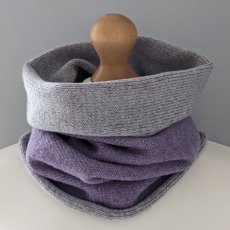 Pale grey and lilac reversible knitted snood worn in neck of mannequin