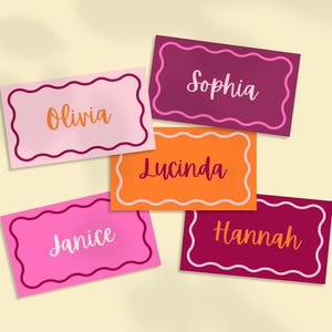 May include: A collection of colorful name cards with scalloped edges. Each card features a different name: Olivia, Sophia, Lucinda, Janice, and Hannah. The cards are in shades of pink, orange, and burgundy, with white and orange text.