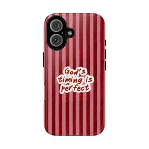 May include: A phone case featuring a vertical striped pattern in alternating shades of dark red and light pink. Centered on the case is a white, cloud-shaped graphic containing the dark red text that reads, God's timing is perfect.
