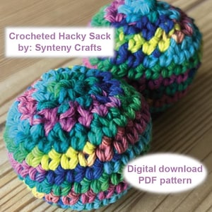 May include: Two round, crocheted hacky sacks featuring a variegated yarn pattern in shades of blue, green, yellow, and pink. Text on the image reads: Crocheted Hacky Sack by: Synteny Crafts and Digital download PDF pattern.