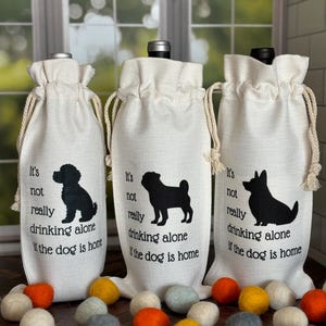 Wine bag made of polyester material along with drawstring to pull shut the bag.  Choose from a 100+ dog silhouette images that is positioned to the right of the words "It's not really drinking alone if the dog is home" Bag fits up to a 750ml of wine