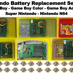 May include: A collection of Nintendo game cartridges with exposed battery compartments. The cartridges are for Game Boy, Game Boy Color, Game Boy Advance, Super Nintendo, and Nintendo 64. The cartridges are arranged in rows on a yellow background. The image also includes a row of replacement batteries.