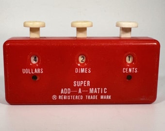 May include: A red rectangular Super Add-A-Matic mechanical adding device with three white push buttons on top. The front displays the text Dollars, Dimes, and Cents with numerical windows showing 4, 2, and 1, plus the registered trademark symbol.