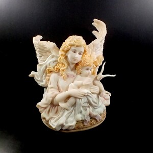 Roman Seraphim Angel Holding a Baby Music box.   Roman Inc