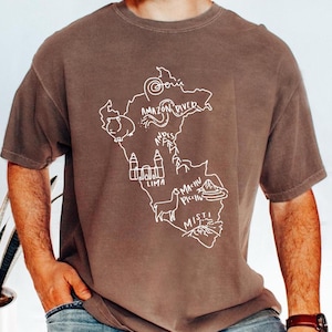 May include: Espresso-colored t-shirt featuring a white outline of a map of Peru with the Amazon River, Andes Mountains, and city names. The shirt has a crew neck and short sleeves. The word "Espresso" is printed in the upper left corner.