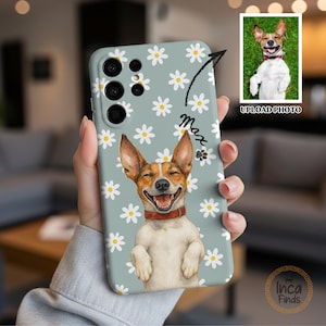 May include: A light blue phone case featuring a repeating white daisy pattern and a central illustration of a smiling brown and white dog wearing a red collar. The name Max is written in black script next to a small paw print icon.