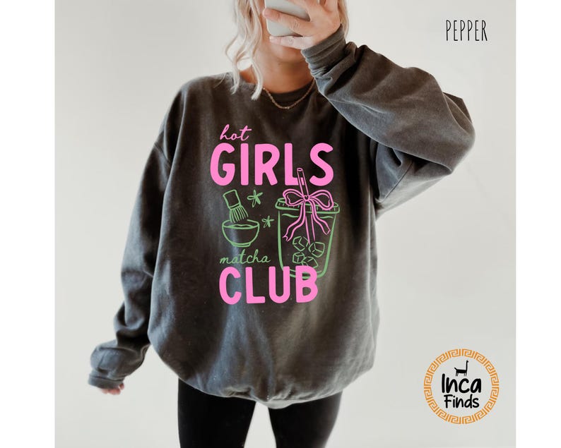 May include: Dark gray sweatshirt with the text "hot GIRLS matcha CLUB" in pink and green. The graphic includes a matcha bowl, whisk, and a matcha drink. The word "Pepper" is printed in black at the top right.