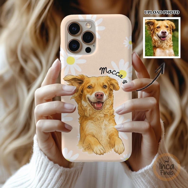 May include: A light peach-coloured phone case featuring a white daisy pattern and a custom illustration of a golden-brown dog. The name Mocca is printed in black script above the dog, accompanied by a small black paw print icon.