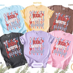 May include: Six t-shirts in shades like chambray, butter, espresso, pepper, orchid, and blossom. Each shirt displays the text "RED, WHITE, and BLONDE" in a patriotic design with red, white, and blue accents, suitable for a summer celebration.