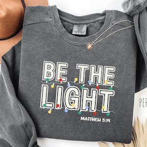 Comfort Colors® Be The Light Sweatshirt, Religious Christmas Gift, Christian Holiday Shirt, Faith Based Gift, Christian Christmas Shirt