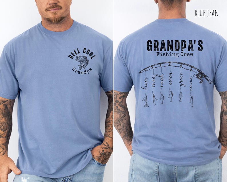 May include: A blue jean colored t-shirt featuring a front graphic of a fish with the text REEL COOL Grandpa. The back displays a fishing rod graphic with the text GRANDPA'S Fishing Crew and six names hanging from the line as fishing lures.