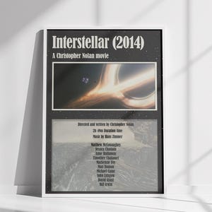 May include: A rectangular movie poster for Interstellar (2014) by Christopher Nolan. The black background features a central image of a glowing black hole in space. Below, text lists the director, 2h 49m duration, music by Hans Zimmer, and cast.