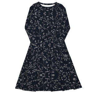 Close-up of gray floral pattern on navy blue jersey knit fabric.
