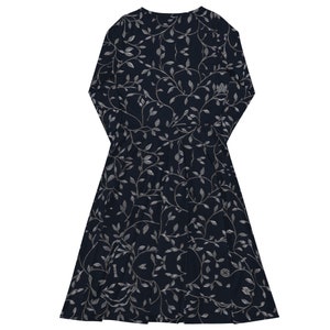 Detail of stitching and seam quality on navy floral midi dress fabric.