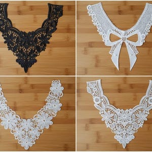 May include: Four decorative lace collars in black and white. The collars have various floral and bow designs. The collars are displayed on a wooden surface.
