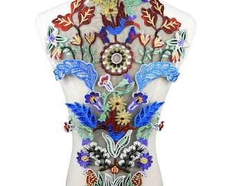 May include: A colorful floral embroidery applique with blue, red, green, yellow, and white flowers on a sheer mesh fabric. The applique is perfect for adding a touch of elegance to clothing, bags, or home decor projects.