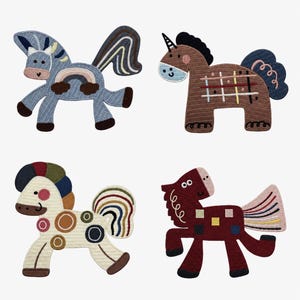 May include: Four embroidered iron-on patches shaped like horses. The top left is blue with a rainbow, the top right is brown with a grid pattern, the bottom left is cream with colourful circles, and the bottom right is dark red with small squares.