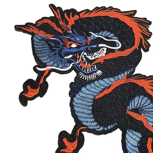 May include: Embroidered patch with a detailed dragon design. The dragon is mainly black with blue and orange accents, showing intricate stitching. The patch is likely for application on clothing or accessories.
