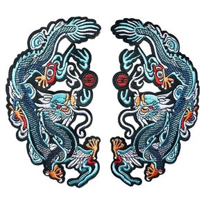 May include: Two embroidered patches with a blue dragon design. The dragons face each other, with detailed embroidery in blue, red, and gold. The patches are set against a white background.