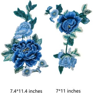May include: Two blue embroidered flower appliques. The larger applique is 7.4 inches by 11.4 inches and features a large blue flower with smaller white flowers. The smaller applique is 7 inches by 11 inches and features a single blue flower.