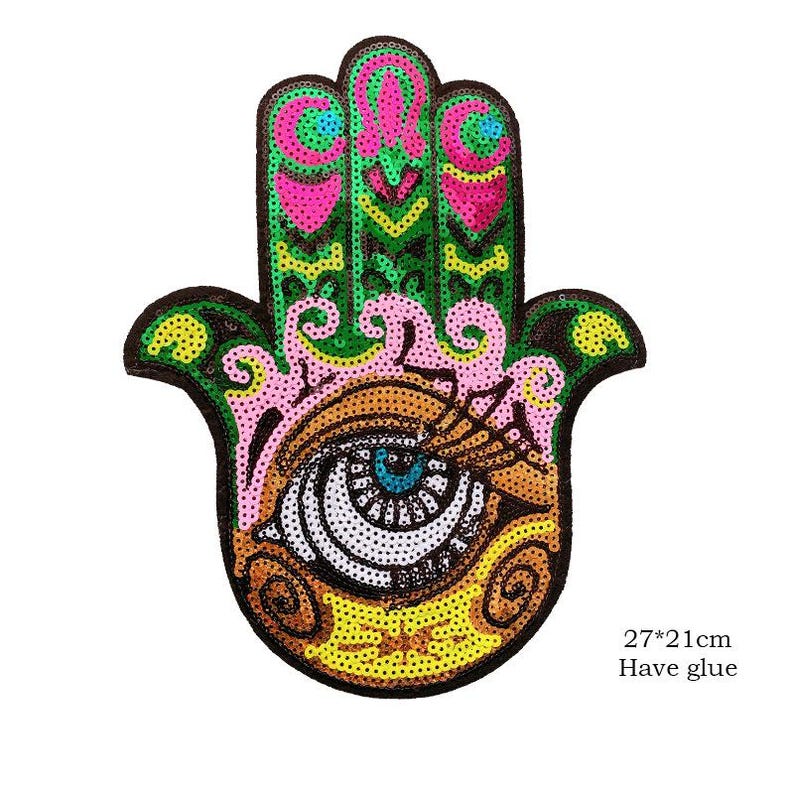May include: A decorative Hamsa hand patch with an eye design. The patch is embellished with sequins in shades of green, pink, yellow, and brown. The patch measures 27cm x 21cm.