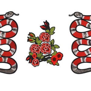 May include: Embroidered patches featuring a red and white striped snake design, and a cluster of red roses with green leaves. The snake patches are in a vertical, winding shape. The floral patch is centered.