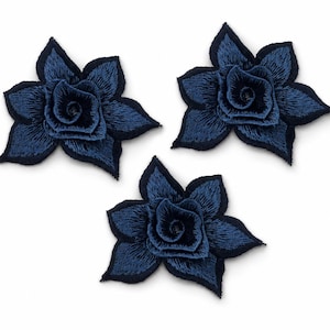 May include: Three identical flower-shaped patches featuring intricate embroidery in shades of deep navy blue. Each patch displays a layered petal design with a central spiral, finished with a dark navy blue stitched border around the outer edges.