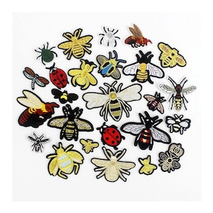 May include: A collection of embroidered iron-on patches featuring various insects, including bees, ladybugs, butterflies, and spiders. The patches are in a variety of colors, including yellow, black, red, and white.