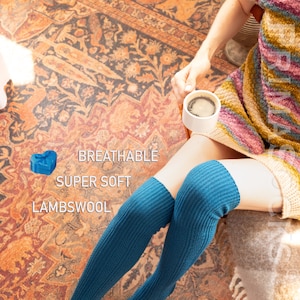 May include: A pair of teal blue knee-high socks made of soft lambswool. The socks are breathable and super soft.